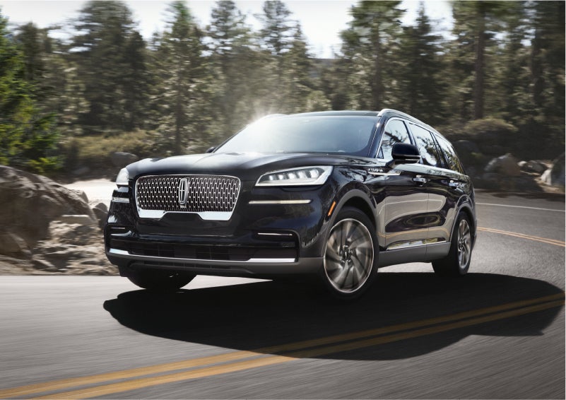 A Lincoln Aviator® SUV is being driven on a winding mountain road | Brinson Lincoln of Athens in Athens TX