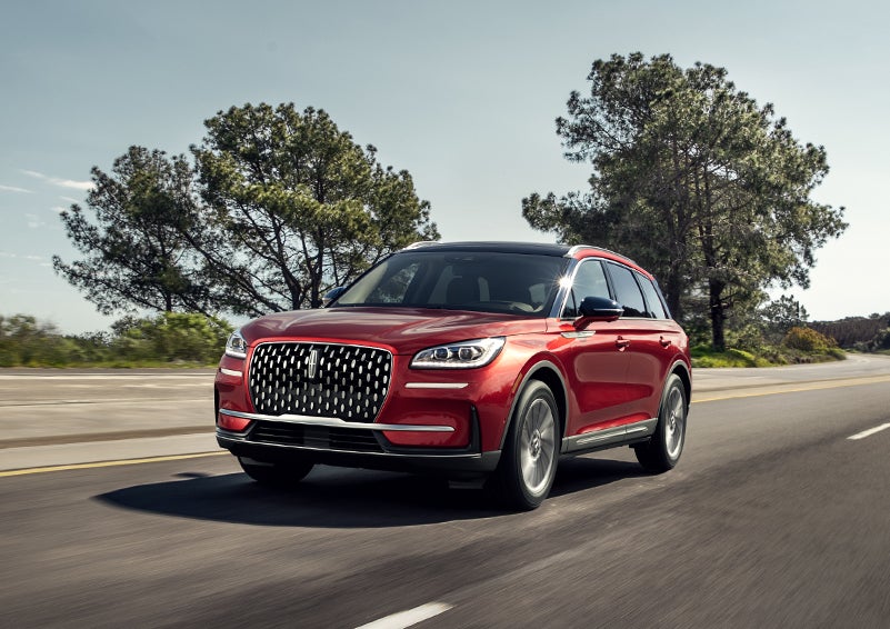A 2024 Lincoln Corsair® SUV is shown being driven on a country road. | Brinson Lincoln of Athens in Athens TX