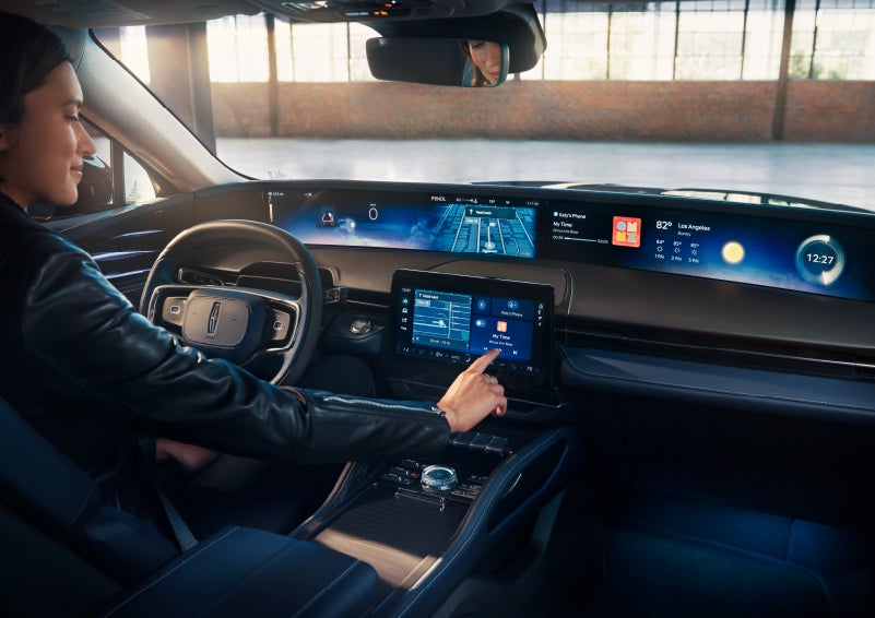 The driver of a 2024 Lincoln Nautilus® SUV interacts with the center touchscreen. | Brinson Lincoln of Athens in Athens TX